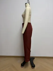 Side view detail of professional high-waisted straight-leg trousers in reddish brown