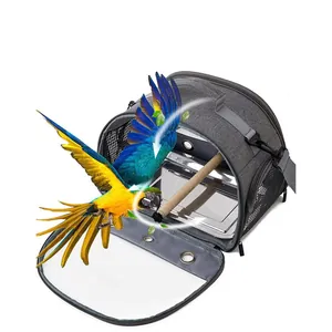 Detailed view of a portable grey bird carrier featuring stainless steel tray and wooden perch