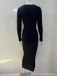 Detailed back view of a black ribbed knit long sleeve bodycon maxi dress on mannequin