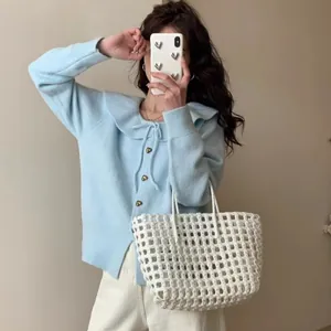 Detail of a light blue sweet style knit cardigan with doll collar and heart buttons