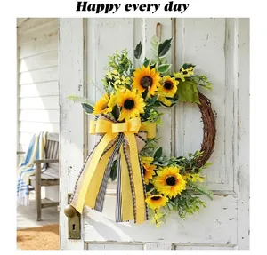 Close-up of artificial sunflower wreath with yellow ribbon on white wooden door