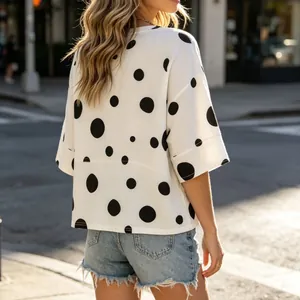 Detailed back view of a white oversized polka dot T-shirt featuring loose flare sleeves