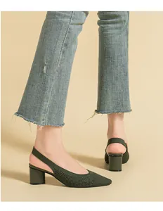 Detailed view of dark green knit slingback pumps featuring pointed toe and block heel.