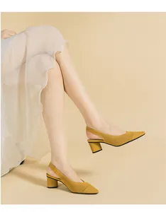 Elegant yellow knitted slingback sandals with a pointed toe and stylish block heel.