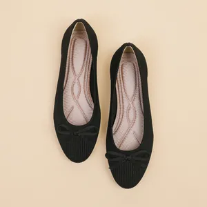 Classic black knit ballet flats featuring a bow detail and a comfortable wavy padded insole