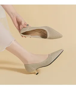 Detail view of breathable beige knitted pointed-toe kitten heel pumps for women