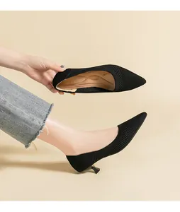Detailed view of black breathable fly-knit pointed-toe pumps with cushioned insoles