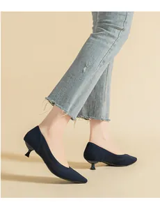 Vista laterale di eleganti décolleté kitten heel in maglia blu navy traforata con jeans.