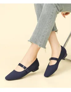 Detailed texture of breathable navy fly-knit Mary Jane flats with buckle strap.