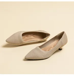 Detail view of beige breathable fly-knit mesh fabric on elegant pointed-toe kitten heel pumps