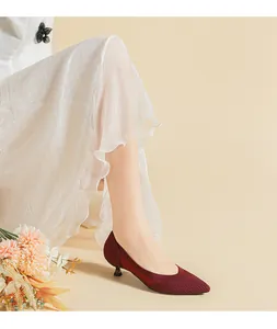 Dettaglio di eleganti scarpe bordeaux a punta con tacco gattino e maglia traspirante