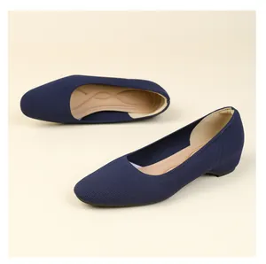 Detail view of navy blue knitted square toe flat shoes with comfortable cushioned insoles