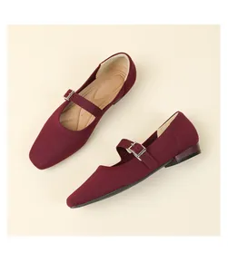 Detailed close-up view of wine red knit Mary Jane flats with elegant buckle strap