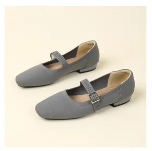 Close-up of grey breathable fly-knit Mary Jane shoes with buckle strap