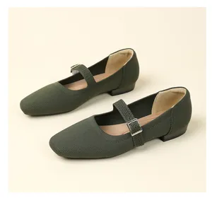 Close-up of olive green knit Mary Jane shoes with adjustable buckle strap detail.