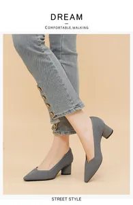Detail view of gray ribbed pointed-toe pumps with chunky heels and V-cut design
