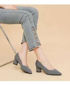 Detail view of grey knit-texture pointed-toe pumps with stable chunky heels