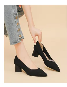 Detailed macro view of black ribbed pointed-toe V-cut block heel pumps for women