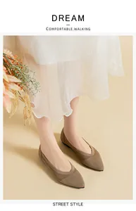 Elegant khaki knitted pointed-toe flats worn with a white skirt for a commute style.