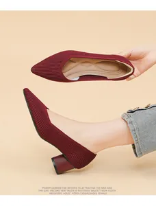 Detailed view of wine red pointed-toe chunky heel pumps with ribbed texture design.