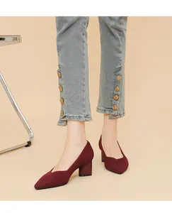 Detailed view of wine red chunky heel pumps with ribbed knit texture and V-mouth