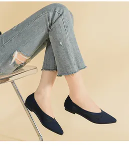 Close-up of navy blue woven pointed flats for women with breathable knit texture