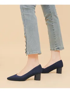 Close-up detail of navy blue ribbed fabric pointed-toe pumps with comfortable block heels