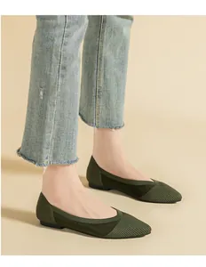 Close-up of olive green knitted pointed flats showing breathable texture on feet