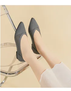 Close-up of grey knitted pointed-toe flat shoes with breathable mesh detail