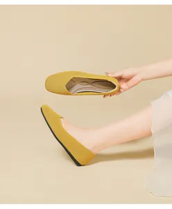 Detail view of yellow square-toe breathable knit flats with a soft flexible sole