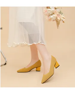 Side view of yellow ribbed pointed-toe chunky heels on a model with elegant V-cut