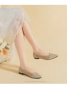 Close-up detail of breathable beige knitted pointed-toe flat shoes worn by a model
