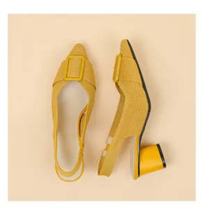 Detailed view of yellow knitted pointed-toe slingback sandals with chunky block heels.