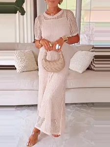 Elegant white hollow-out crochet maxi dress featuring a chic two-piece design for summer