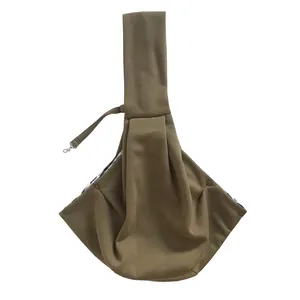 Detailed view of the olive green pet sling carrier with secure button fasteners.
