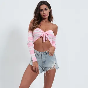Close-up detail of a pink and white striped knitted crop top with front bowknot