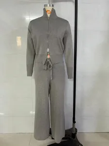 Detailed view of grey knitted two-piece tracksuit featuring a zip-up cardigan and wide-leg pants.