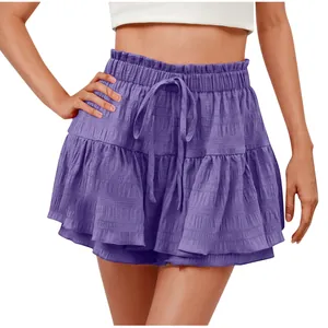 Close-up detail of women's purple ruffled drawstring skort with textured fabric finish.
