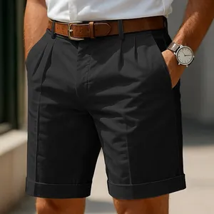 Detailed close-up of men's black business casual pleated shorts featuring a cuffed hem