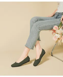 Elegant olive green knitted flat shoes for women styled with casual denim jeans