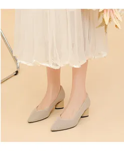 Detailed view of apricot ribbed knit pointed-toe pumps featuring V-vamp and chunky heels