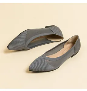 Detail view of grey woven pointed-toe flats featuring breathable mesh side panels.
