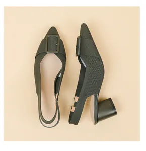 Detailed view of olive green knitted pointed-toe slingback pumps with block heel