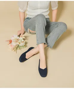 Close-up of navy blue breathable fly-knit flat shoes with a stylish square toe