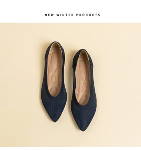 Detailed view of navy blue knit pointed-toe flat shoes featuring breathable insoles