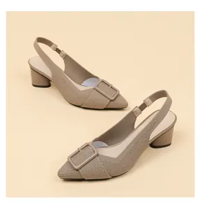 Close-up of elegant pointed-toe knitted slingback shoes with chunky heels and buckles