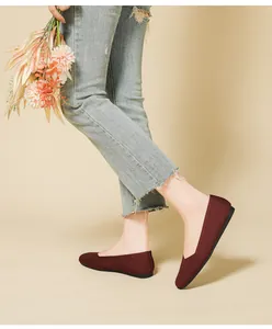 Side view of burgundy breathable flyknit square toe flat shoes worn with denim jeans