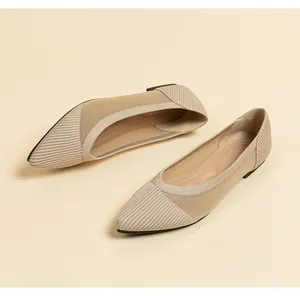 Detailed view showing the breathable knit texture of these beige pointed-toe flats