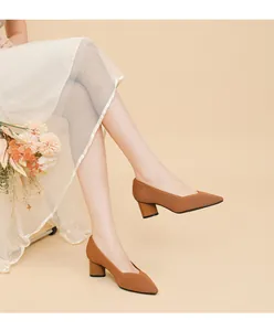 Elegant close-up view of brown knitted pointed-toe pumps with chunky block heels