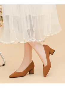 Detail view of caramel knitted block heel pumps with elegant V-cut pointed toe on model.